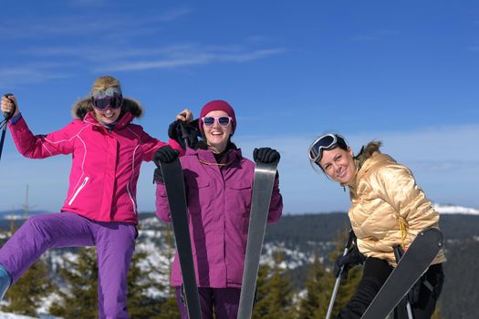 happy friends group of woman girls have fun at winter season at beautiful sunny  snow day with blue sky in background