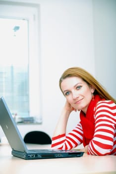 woman in red working on laptop at bright  office