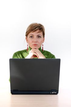 businesswoman in green working on laptop