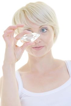 Beautiful blonde woman hold diamond gem isolated over white background in studio