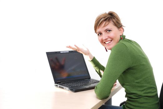 businesswoman in green working on laptop