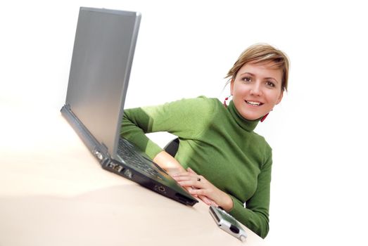 businesswoman in green working on laptop