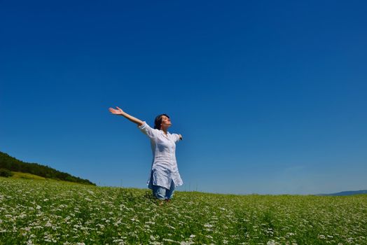 healthy Happy  young woman with spreading arms, blue sky with clouds in background  - copyspace