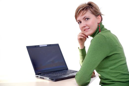 businesswoman in green working on laptop