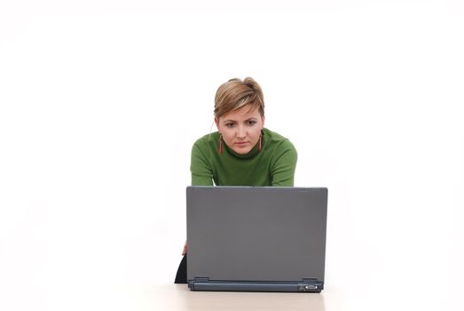 businesswoman in green working on laptop