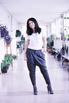 young happy business woman or student posing in fashionable clothes indoor in bright building 