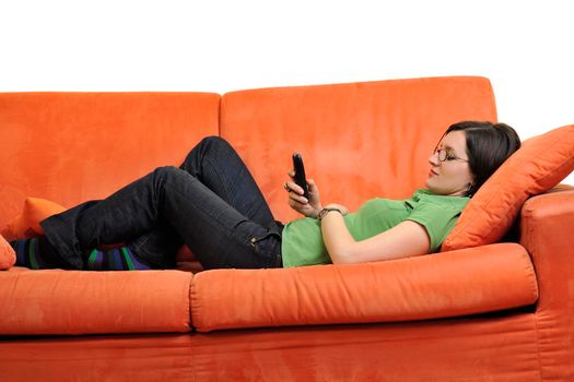 happy young woman relax on orange sofa  at home isolated on white background in studio
