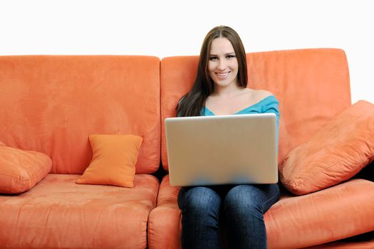 young business woman in casual clothes working on laptop computer on orange sofa isolated on white