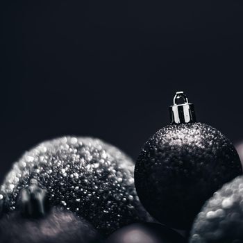 Christmas holiday and festive decoration concept. Black baubles as minimalistic xmas background.