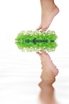 woman legs walking on small peace of green grass isolated on white representing last oasis concept