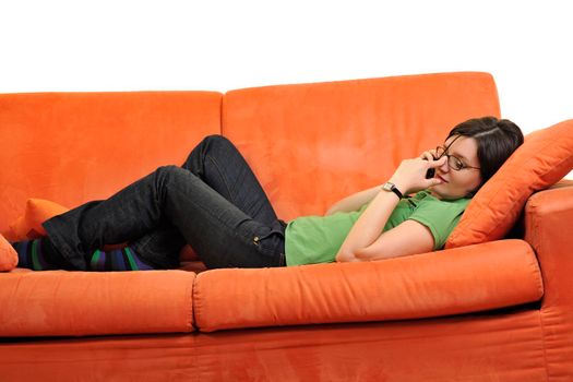 happy young woman relax on orange sofa  at home isolated on white background in studio