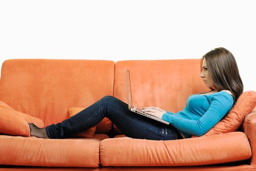 young business woman in casual clothes working on laptop computer on orange sofa isolated on white