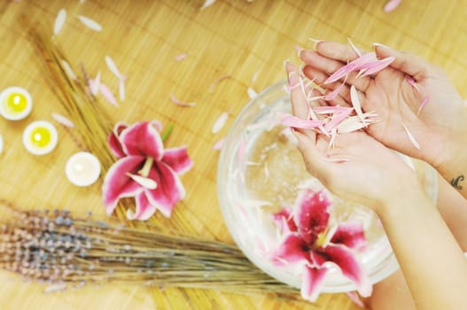 hand spa and beauty treatment with aroma and flowers in water