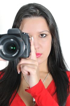 Young woman holding camera in hand taking picture isolated