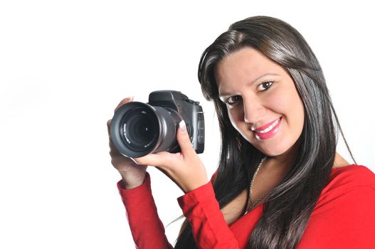 Young woman holding camera in hand taking picture isolated