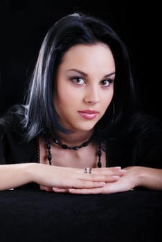 one young beautiful brunette  woman in black posing in studio