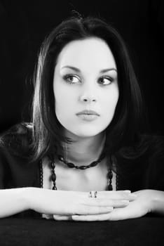 one young beautiful brunette  woman in black posing in studio