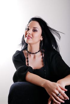 one brunette woman posing in studio 