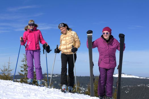 happy friends group of woman girls have fun at winter season at beautiful sunny  snow day with blue sky in background