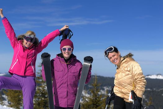 happy friends group of woman girls have fun at winter season at beautiful sunny  snow day with blue sky in background