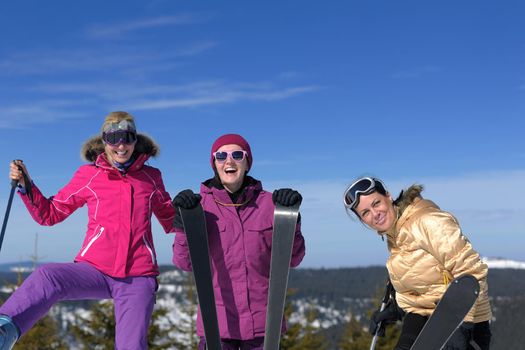 happy friends group of woman girls have fun at winter season at beautiful sunny  snow day with blue sky in background