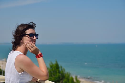 happy young tourist woman have fun while traveling araund city with blue sky and sea in background