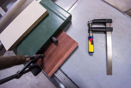 clamp and ruler tools on desk in factory for the production of wooden furniture