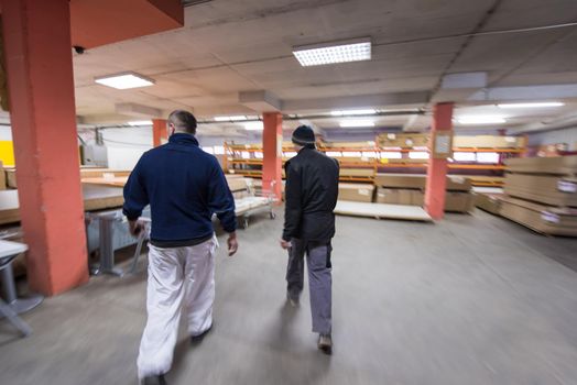 two young carpenters working together in big modern carpentry High quality wood concept