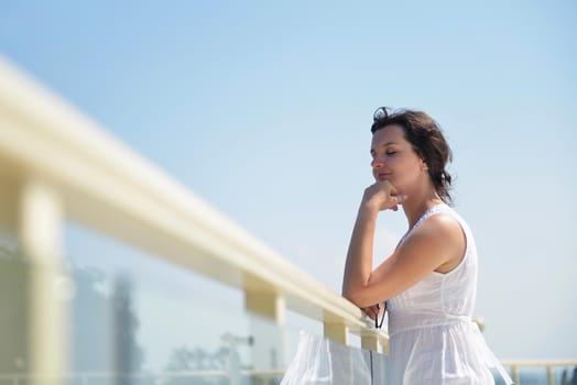 happy young tourist woman have fun while traveling araund city with blue sky and sea in background