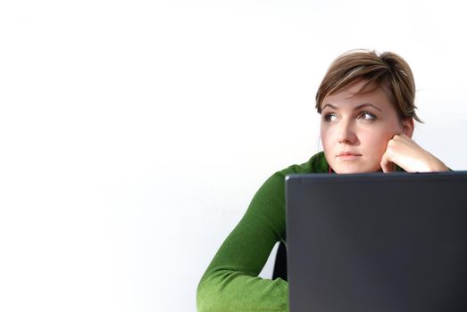 businesswoman in green working on laptop
