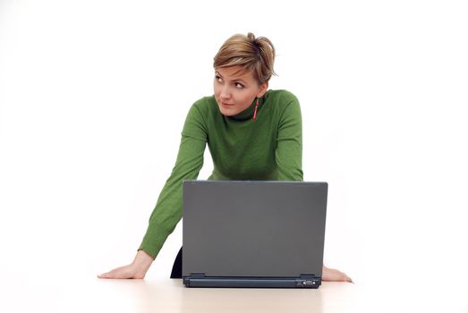 businesswoman in green working on laptop