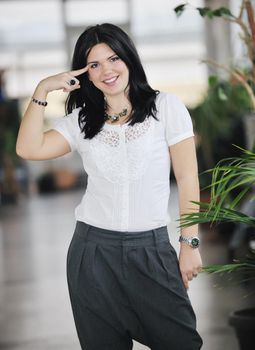 young happy business woman or student posing in fashionable clothes indoor in bright building 