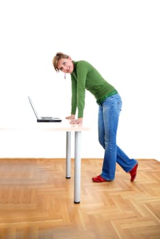 business woman in green standing in office