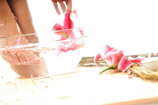 woman spa pedicure foot treatment with water and flower