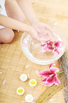 hand  and nail spa and beauty treatment with aroma and flowers in water isolated on white