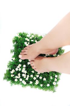 woman legs walking on small peace of green grass isolated on white representing last oasis concept