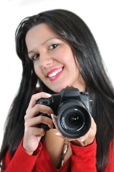 Young woman holding camera in hand taking picture isolated