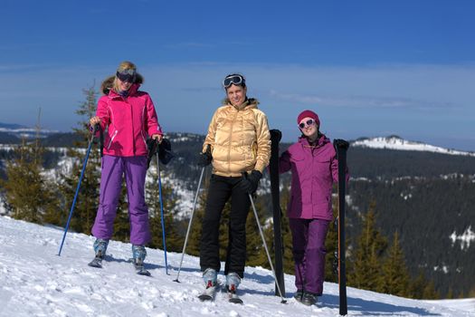 happy friends group of woman girls have fun at winter season at beautiful sunny  snow day with blue sky in background