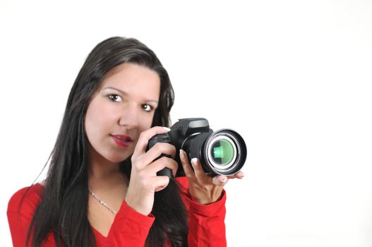 Young woman holding camera in hand taking picture isolated