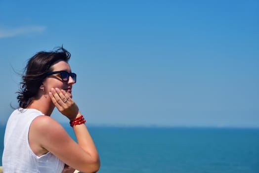 happy young tourist woman have fun while traveling araund city with blue sky and sea in background