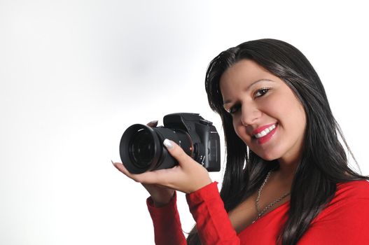 Young woman holding camera in hand taking picture isolated