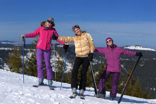 happy friends group of woman girls have fun at winter season at beautiful sunny  snow day with blue sky in background