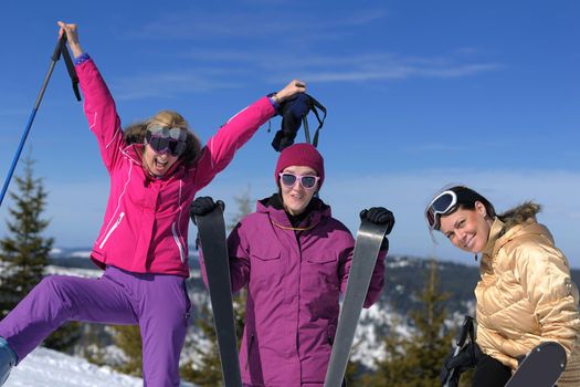 happy friends group of woman girls have fun at winter season at beautiful sunny  snow day with blue sky in background