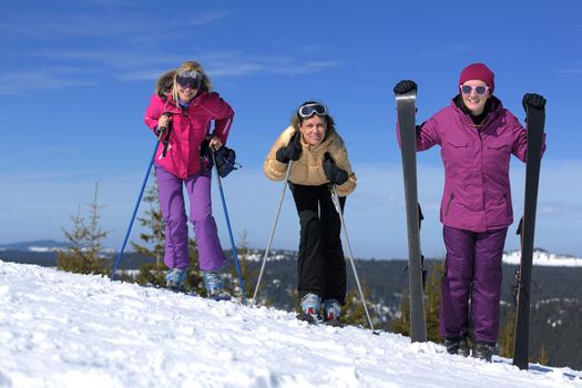 happy friends group of woman girls have fun at winter season at beautiful sunny  snow day with blue sky in background