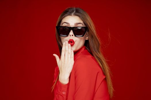 glamorous woman wearing sunglasses red shirt hairstyle model. High quality photo