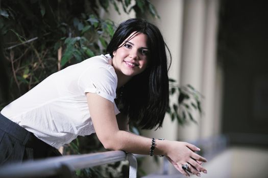 young happy business woman or student posing in fashionable clothes indoor in bright building 