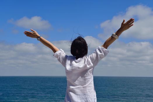 healthy Happy  young woman with spreading arms, blue sky with clouds in background  - copyspace