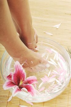 woman spa pedicure foot treatment with water and flower