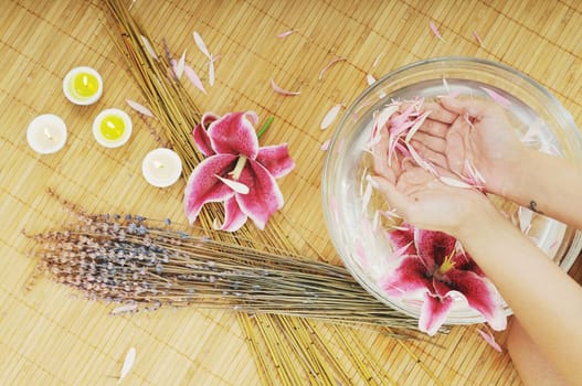 hand spa and beauty treatment with aroma and flowers in water
