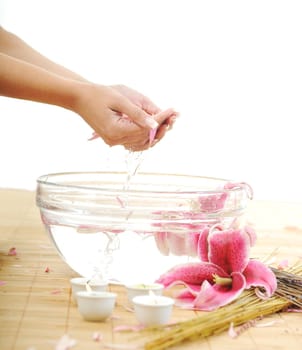 hand spa and beauty treatment with aroma and flowers in water